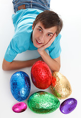 Image showing Boy with a bunch of chocolate easter eggs