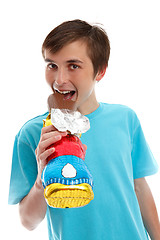 Image showing Smiling happy child eating chocolate easter