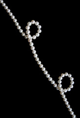 Image showing White pearls on the black velvet  background