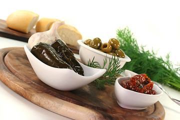 Image showing Olives, stuffed vine leaves and dried tomatoes