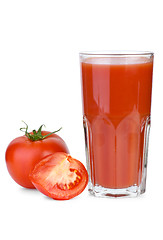 Image showing Drinking glass filled with tomato juice and tomatoes near