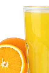 Image showing Closeup shot of drinking glass with orange juice and oranges