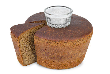 Image showing Cut loaf of round rye bread and salt jar