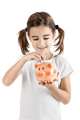 Image showing Little girl with a piggy-bank