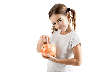 Image showing Little girl with a piggy-bank