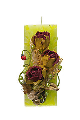 Image showing Large green candle with the flower decoration