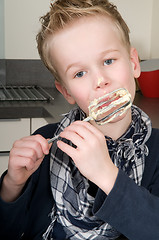 Image showing Boy Eating Dough From A Beater