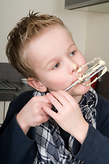 Image showing Boy Eating Dough From A Beater