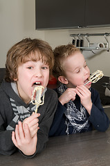 Image showing Boys Eating Dough From A Beater