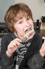 Image showing Boy Eating Dough From A Beater