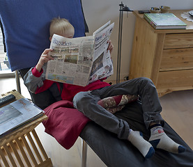 Image showing Teen reading newspaper