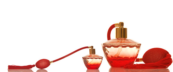 Image showing Perfume in a red glass bottles