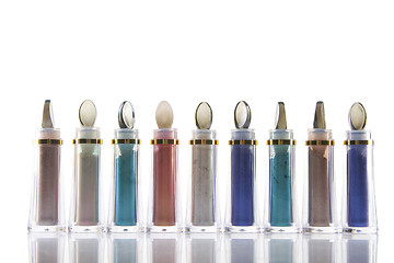 Image showing bottle with different colors of cosmetics