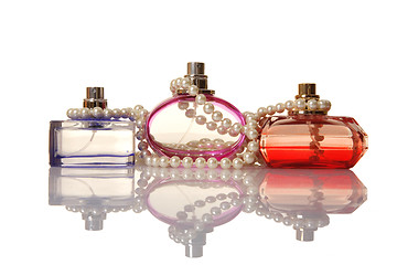 Image showing Perfume in a glass bottles and pearl beeds