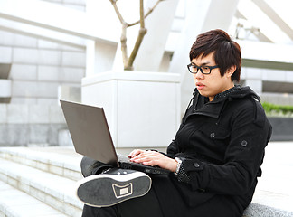 Image showing man using computer outdoor 