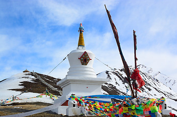 Image showing White Tibetan pagoda near snow mountain