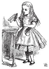 Image showing Drink me. Alice is picking up a small bottle on the table, which