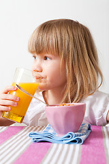 Image showing Little girl eating breakfast