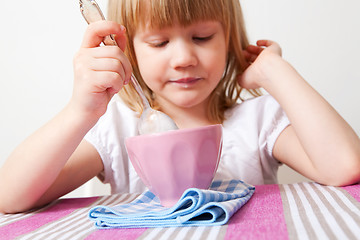 Image showing Little girl eating breakfast