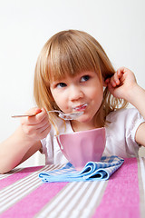 Image showing Little girl eating breakfast