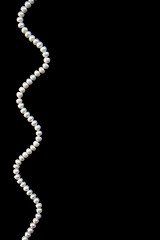 Image showing White pearls on the black silk