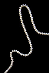 Image showing White pearls on the black silk 