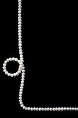 Image showing White pearls on the black silk 