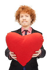 Image showing handsome man with red heart-shaped pillow