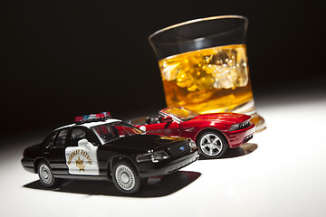 Image showing Police and Sports Car Next to Alcoholic Drink