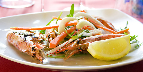 Image showing Italy.Royal shrimps fried on a grill with vegetables 