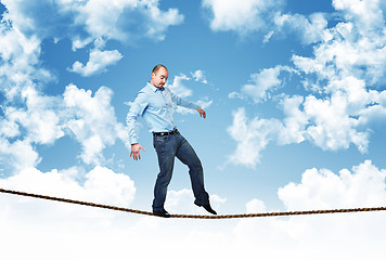 Image showing man walk on rope