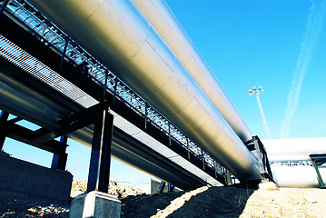 Image showing Industrial zone, Steel pipelines and valves against blue sky