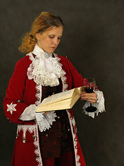 Image showing Woman in old-fashioned french clothes reading a book