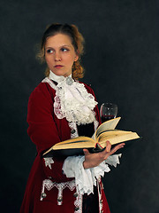 Image showing Woman in old-fashioned french clothes with a book