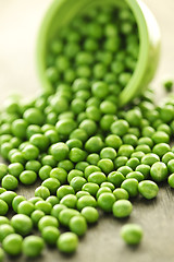 Image showing Spilled bowl of green peas