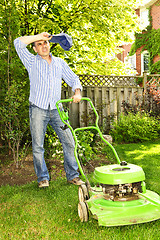 Image showing Man mowing lawn