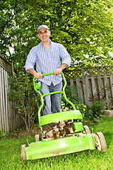 Image showing Man mowing lawn