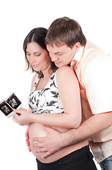 Image showing Couple holding a sonogram of their child