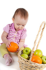 Image showing Baby girl in pink and fruits