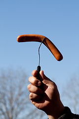 Image showing Hand holding sausage