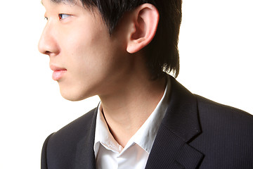 Image showing Young businessman standing and looking right,