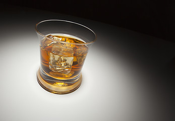 Image showing Glass of Whiskey and Ice Under Spot Light