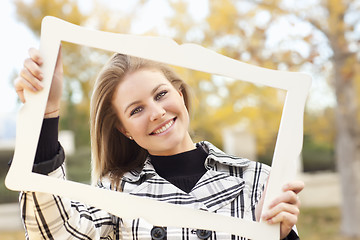 Image showing Pretty Young Woman Smiling in the Park with Picture Frame