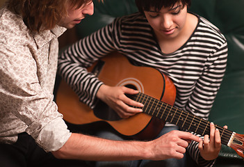 Image showing Young Musician Teaches Female Student To Play the Guitar
