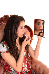 Image showing Girl putting lipstick on.