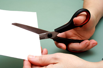 Image showing women hand  cutting paper with scissors