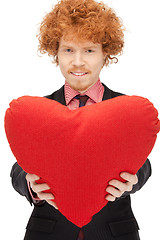 Image showing handsome man with red heart-shaped pillow