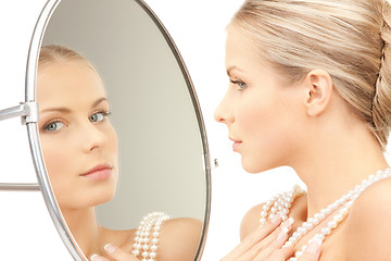 Image showing beautiful woman with pearl beads and mirror