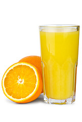 Image showing Drinking glass with orange juice and oranges near