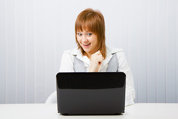 Image showing joyful surprise a girl with a laptop